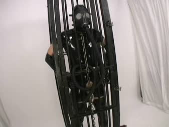 Alice In BondageLand - FemDom Fetish Movies - Gas Mask Chastity Pt 3 Caged Gimp Double Domme Threesome